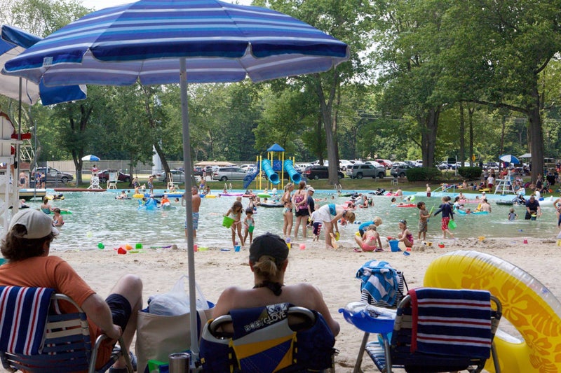 Parents overlooking their children playing in a waterpark in Chatham Township, New Jersey
